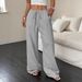 2025 Summer New Women's Casual Solid Color Textured Fabric Knotted Waist Oblique Pocket Wide Leg Pants_ecoleips.com