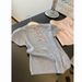 ng2510292 Shenzhen Nanyou High-Quality Women's Clothing: Lightweight Knit Short-Sleeve T-Shirt With Intricate Back Cutout And Bow_ecoleips.com